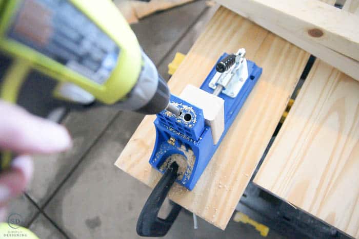 close up of using kreg jig to build floating shelves