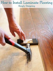 Installing+Floating+Laminate+Floors+Taping+the+wood+in+place1 How to Install Floating Laminate Wood Flooring {Part 2}: The Installation 1