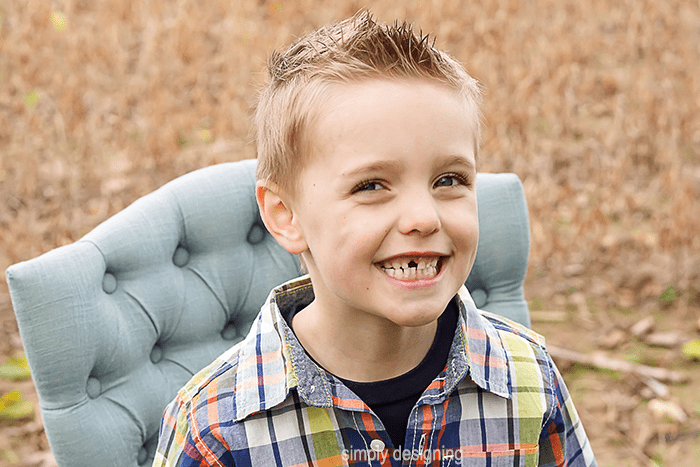 family Photo of Boy sitting in a chair in a field Close Up