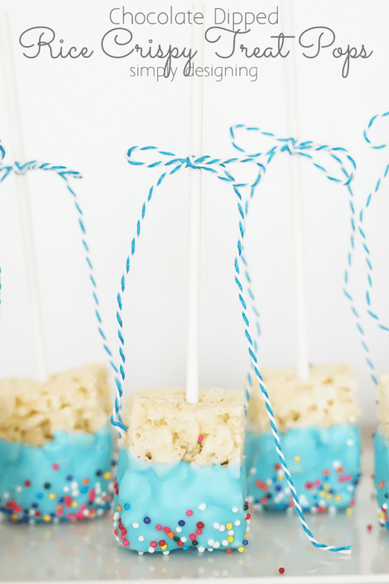 Plate of Blue Chocolate Dipped Rice Crispy Treat Pops on a platter with twine bows on the stems