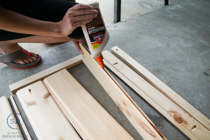 Using Elmer's Wood Glue Max to glue the car siding boards together to make a baby gate