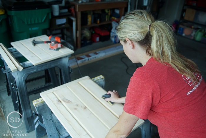 Using 80 grit and then 120 grit sandpaper (and 220 for extra good measure) to sand the doors, posts and clamps down