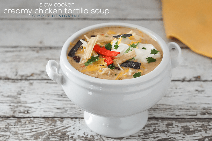Creamy Chicken Tortilla Slow Cooker Soup in a white bowl topped with tortilla strips