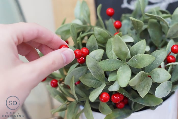 add berries to greenery for holiday touch