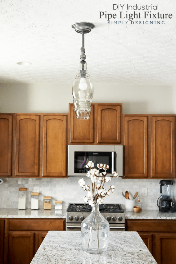 side view of DIY Light Fixture pendent light over kitchen bar with cabinets in the background