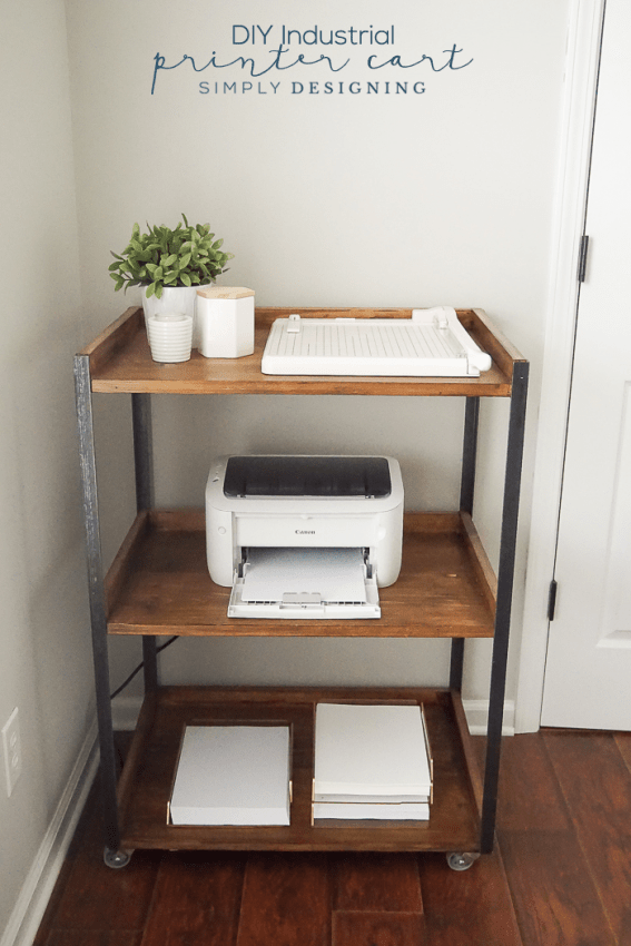 Industrial DIY Printer table with three shelves and caster wheels holding paper, printer, paper cutter and decorative items