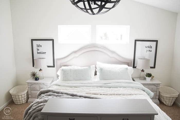Master Bedroom Makeover with painted grey bedside tables, typography prints and cozy bedding