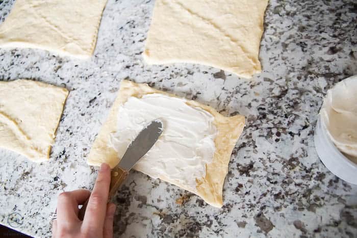 spread cream cheese mixture on crescent roll dough