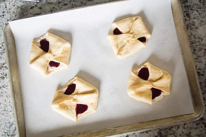 put berry cheese danish on baking sheet