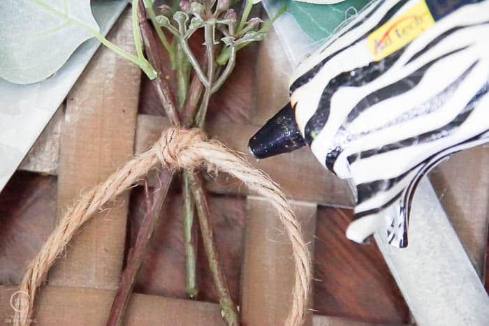 hot glue greenery to tobacco baskets