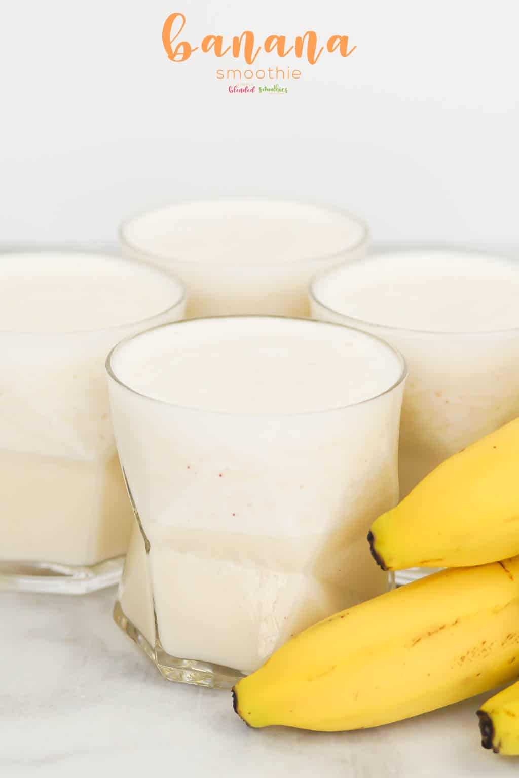 Banana Smoothie 4 smoothie made with bananas in glass with bananas on the side