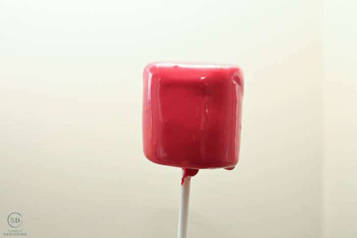 dip marshmallow pop in red chocolate
