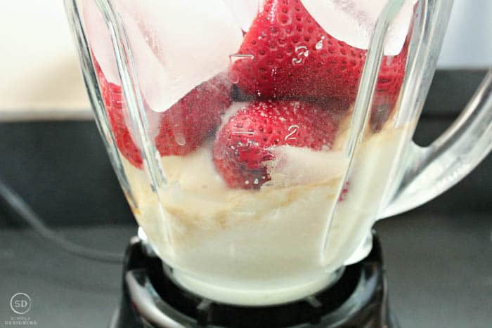Strawberry Cheesecake Smoothie ingredients in a blender