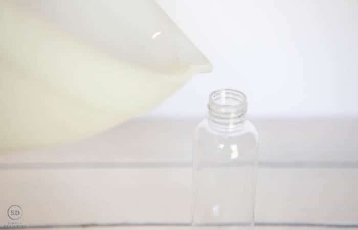 pour hand sanitizer into a pump bottle