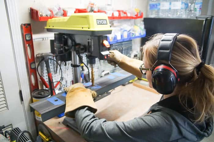 Use drill press to drill holes in channel for DIY vanity lights