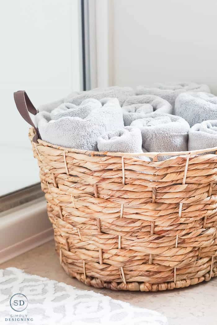 basket with gray towels in it