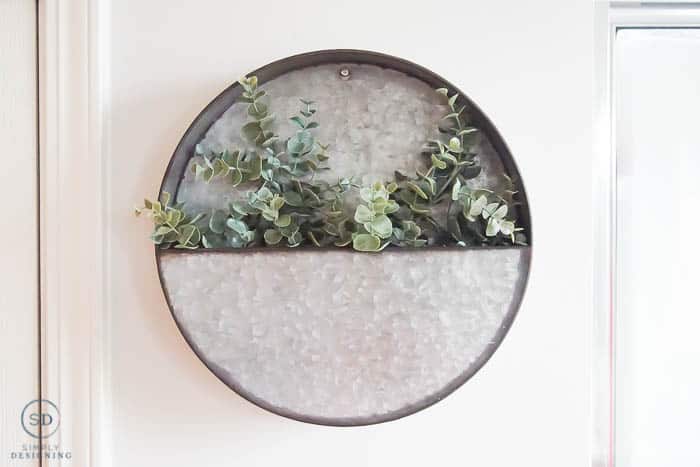 round metal shelf with greenery inside