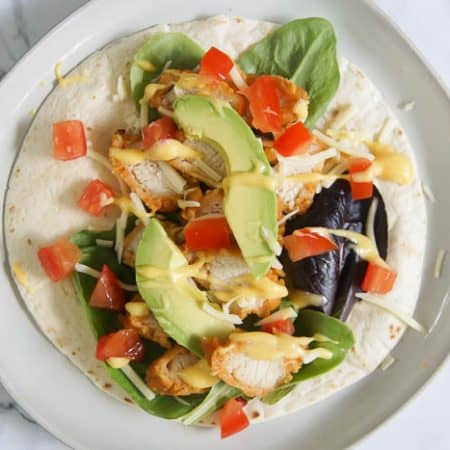 Crispy Chicken Wrap - tortilla with lettuce and chicken and cheese and avocado and tomato and honey mustard dipping sauce