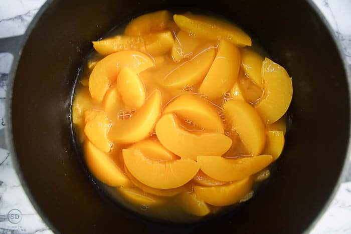 peaches in dutch oven for easy peach cobbler recipe