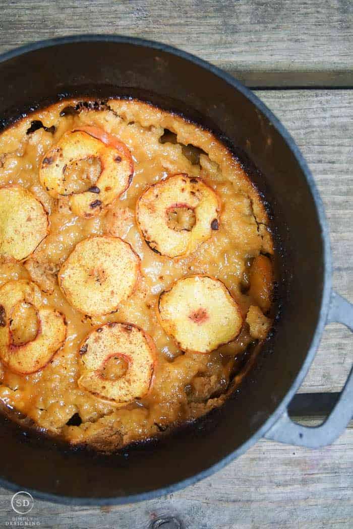 this easy peach cobbler recipe is made in the dutch oven and has fresh grilled peaches on top of it