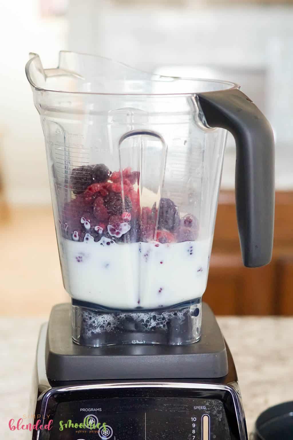 Berry Smoothie 9 smoothie ingredients in a blender vertical photo
