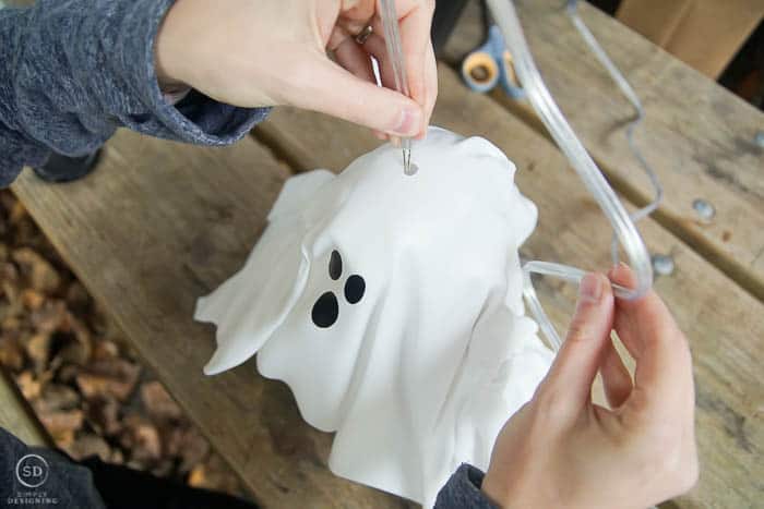 feed lamp cord through hole in hanging ghost lantern