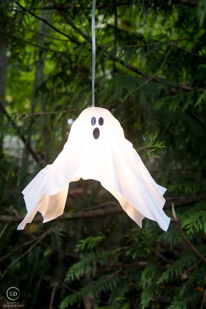 DIY Hanging Ghost Lantern hanging in a tree and turned on