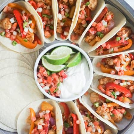 Sheet Pan Fajitas Chicken in corn tortillas with peppers onions and pineapple