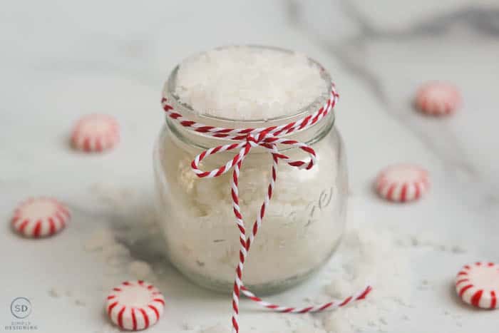 Peppermint Sugar Scrub in a glass jar with red and white twine around the jar