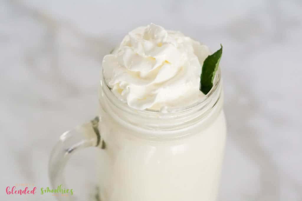 delicious vanilla frappe with whipped cream and a mint leaf