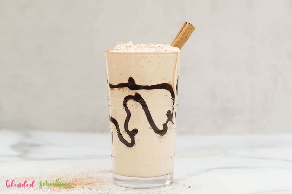 Eggnog Milkshake 5 eggnog milkshake with a cinnamon stick in it and chocolate swirl