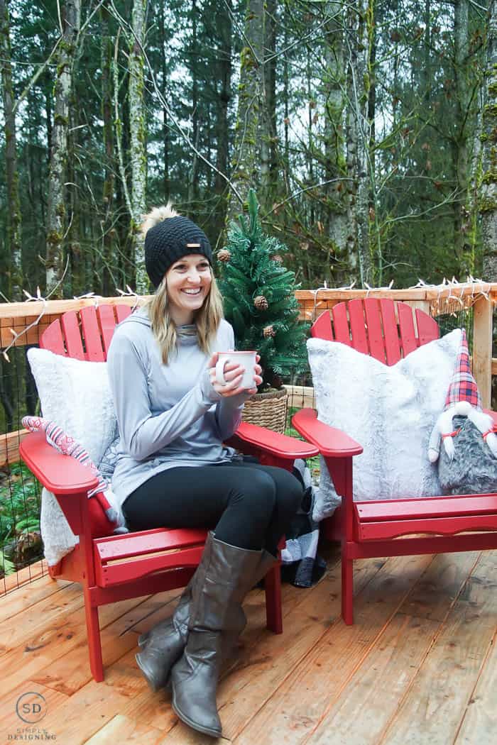 woman sitting in a red adirondack chair