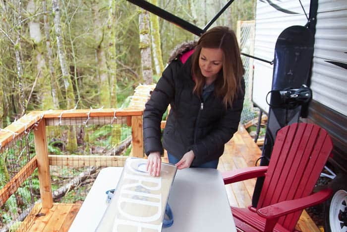 use a scrapper to remove excess wax on snowboard