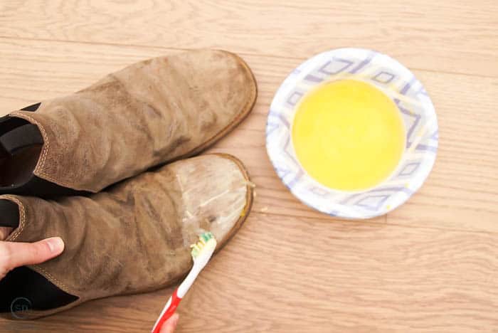 use toothbrush to apply beeswax to leather boots for waterproofing