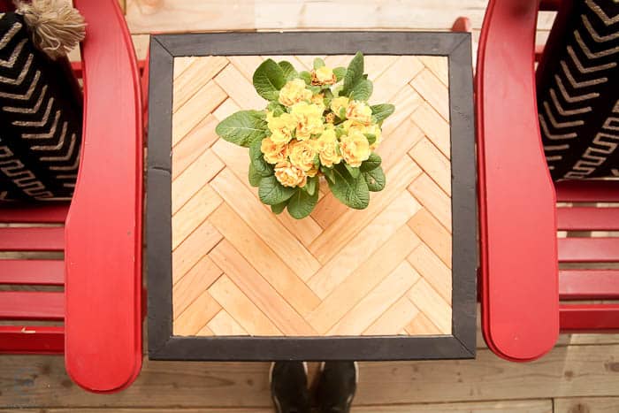 herringbone side table with yellow flowers on top
