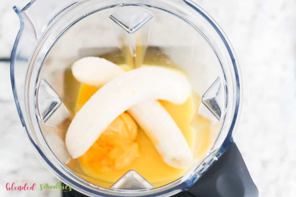 Orange Banana Smoothie 6 orange juice and orange juice concentrate and bananas in a blender from the top looking down into a blender