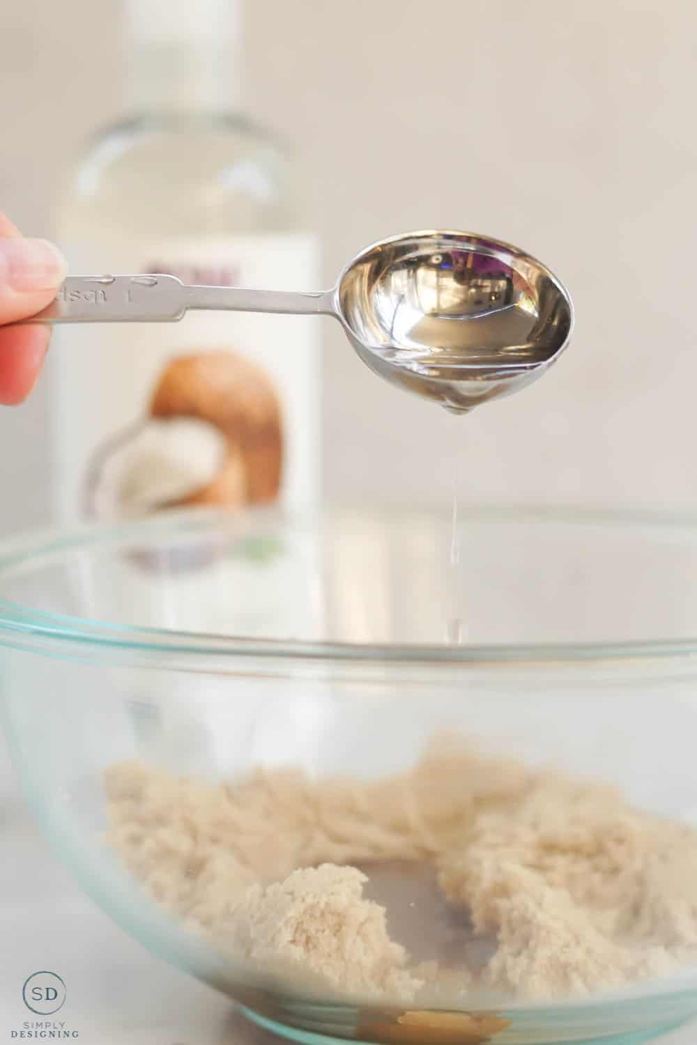 pour fractionated coconut oil into brown sugar