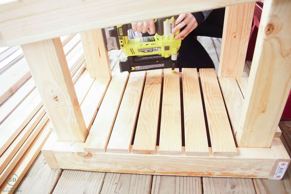 use nail gun to attach flooring boards in cat house