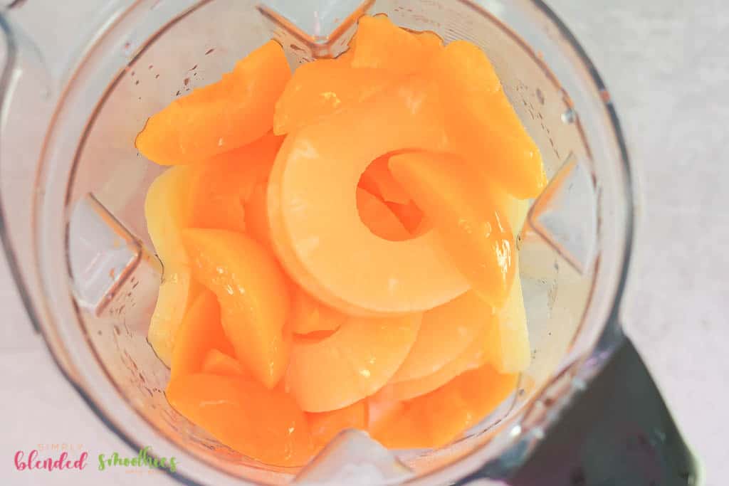 Peach Pineapple Milkshake 8 peaches and pineapple in a blender looking from the top down into the blender