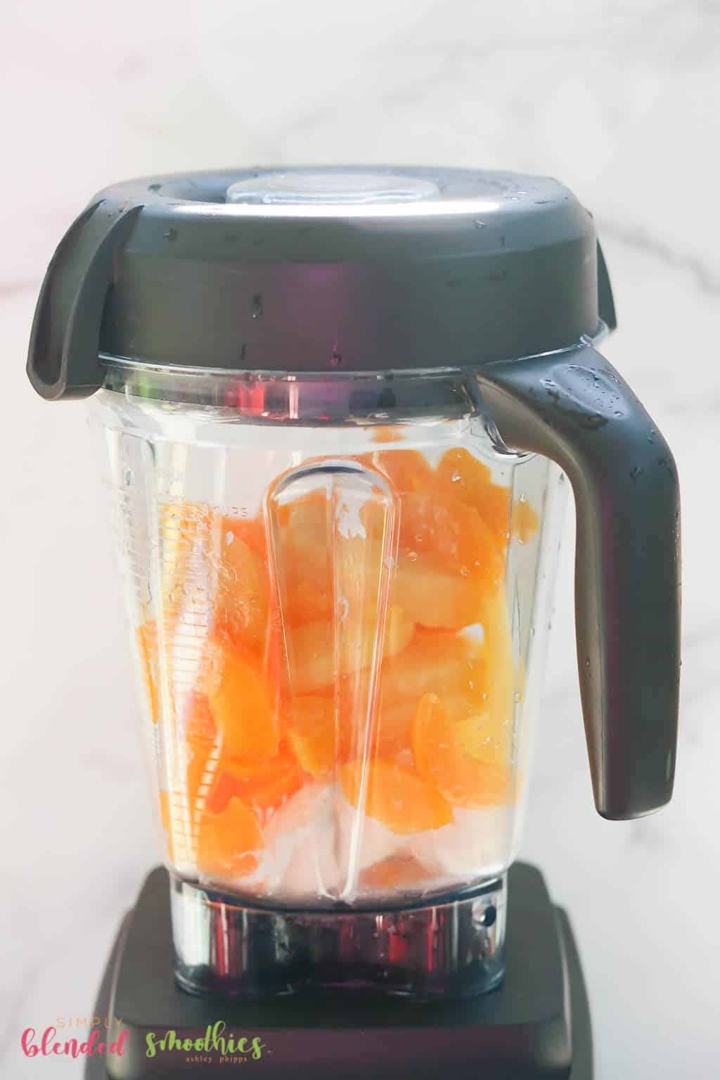 Peach Pineapple Milkshake 9 all ingredients for a milkshake made with peaches and pineapple in a blender looking at it from the side