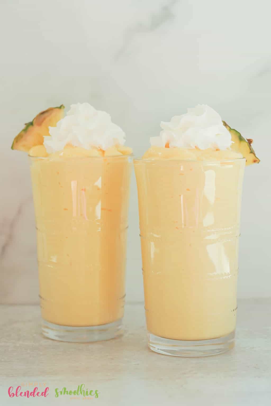 Mango Pineapple Milkshake 6 two milkshakes made with pineapple and mango and topped with whipped cream and pineapple slice