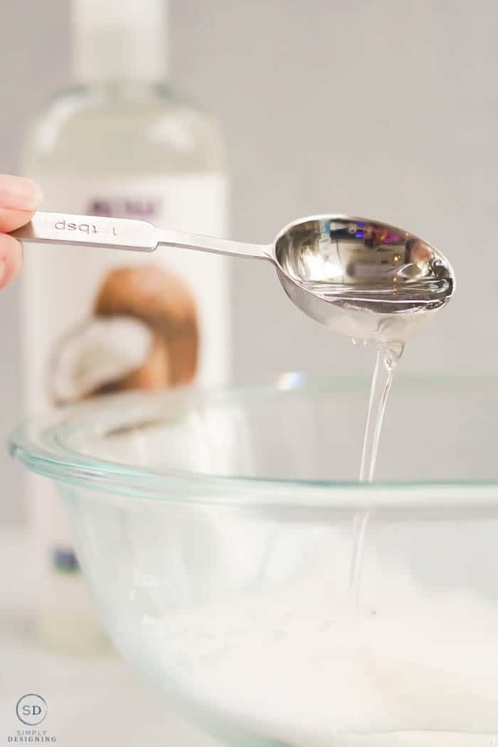 measure and pour fractionated coconut oil with tablespoon