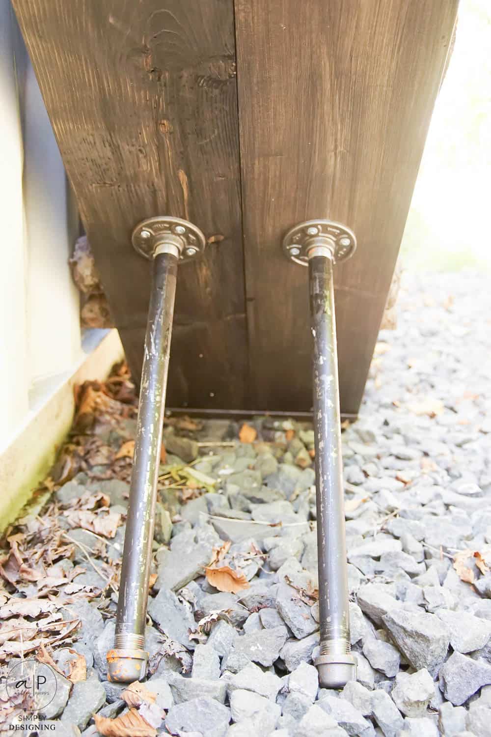 close up of pipe legs on firewood rack