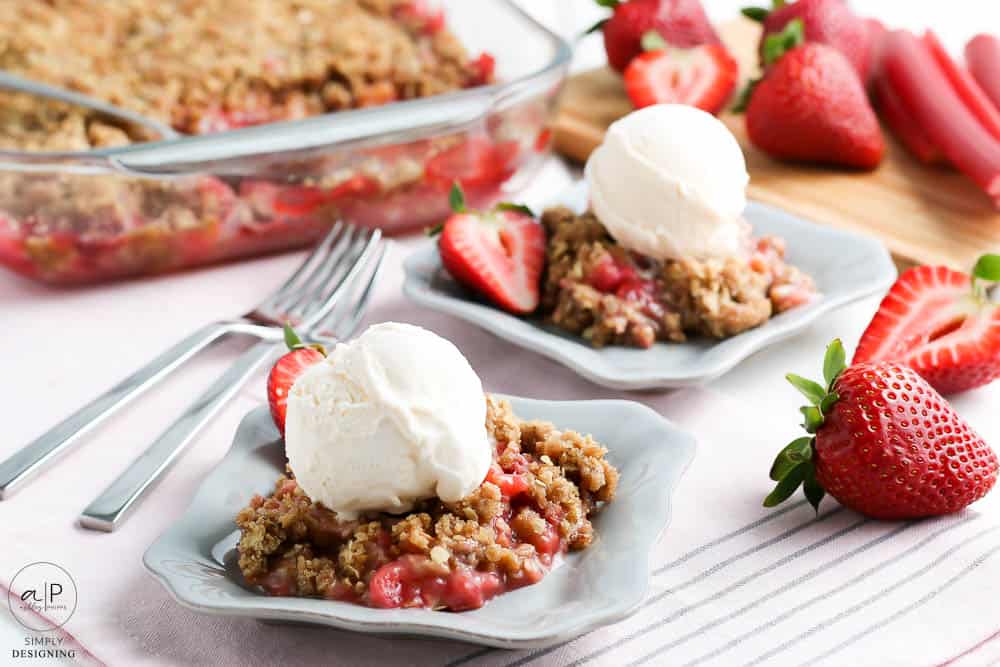 crisp made with rhubarb and strawberries served on a plate with ice cream