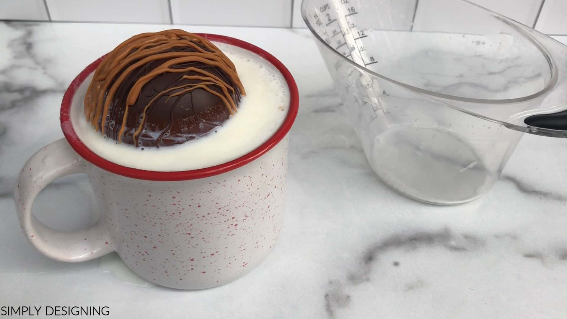 caramel hot cocoa bomb in a mug of hot milk