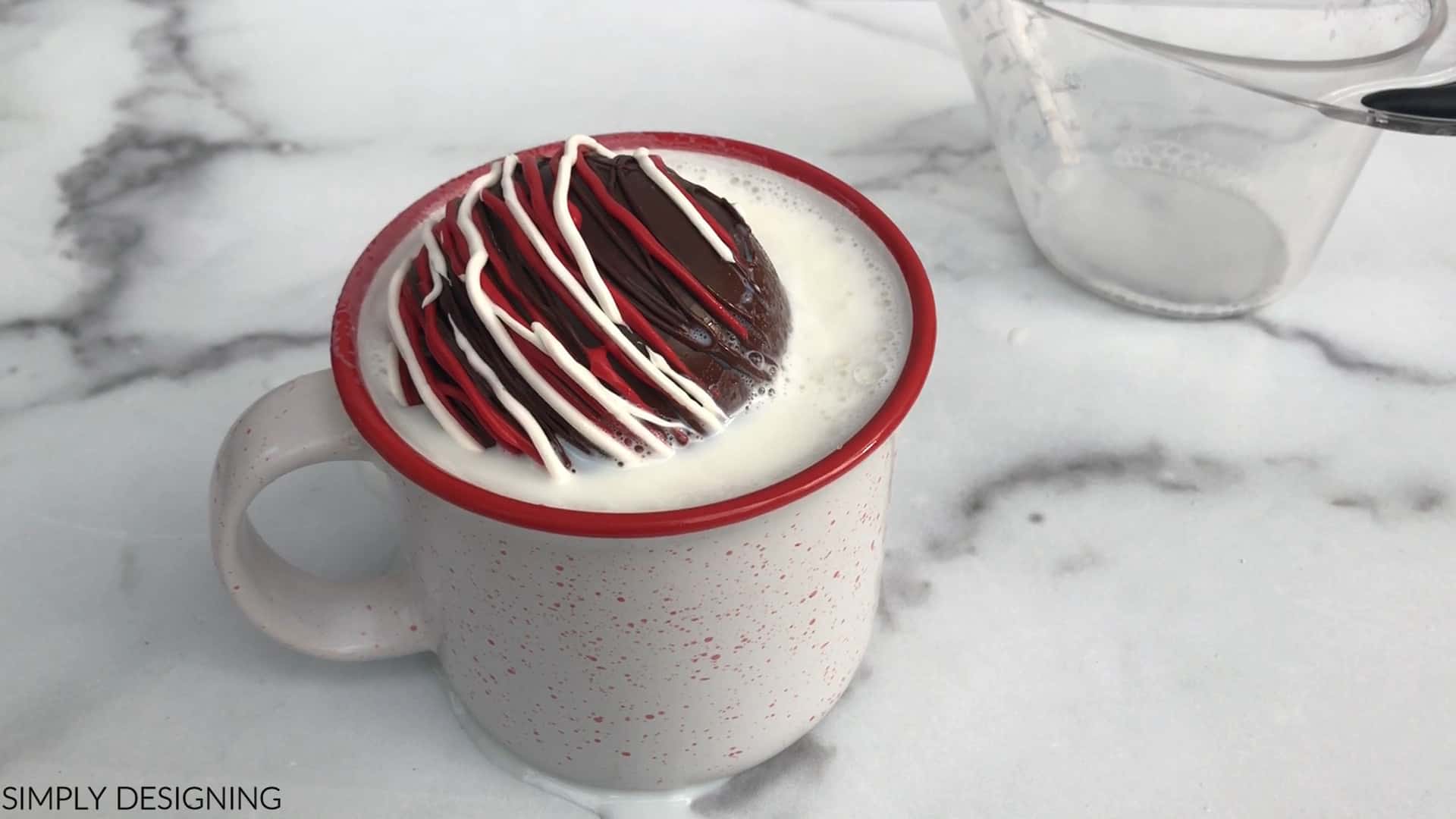 peppermint hot cocoa bomb in mug with hot milk