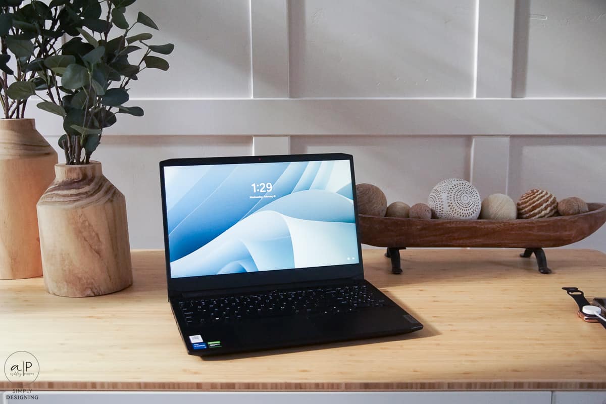 close up on standing desk with a black laptop on it and other decor