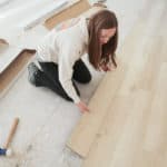 woman installing lpv flooring