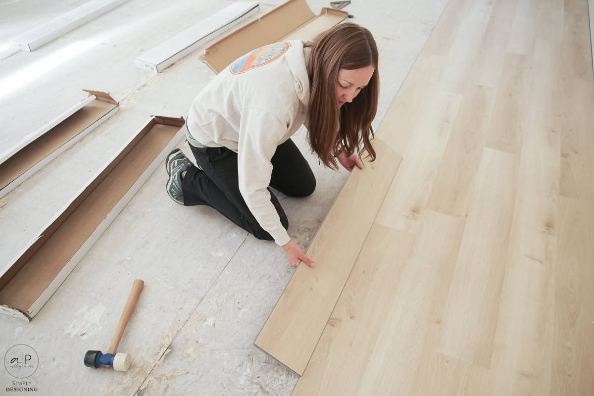 woman installing lpv flooring
