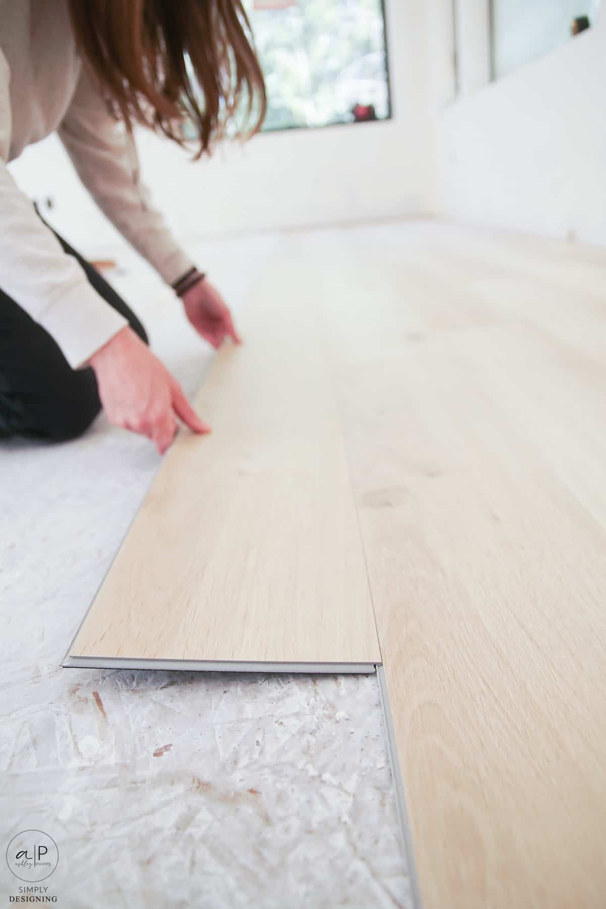 gently pushing down lvp flooring for installation